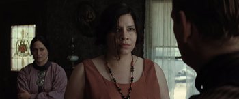 Movie still from “Killers of the Flower Moon” (2023), directed by Martin Scorsese – A woman wearing a red dress and a black necklace; Close Up shot, Low angle