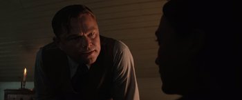 Movie still from “Killers of the Flower Moon” (2023), directed by Martin Scorsese – A man in a suit and tie looking at another man in a suit and tie; Close Up shot, Over the shoulder angle