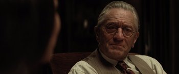 Movie still from “Killers of the Flower Moon” (2023), directed by Martin Scorsese – An old man with glasses and a mustache; Close Up shot, Over the shoulder angle