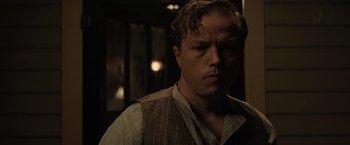 Movie still from “Killers of the Flower Moon” (2023), directed by Martin Scorsese – A person wearing a shirt and vest; Close Up shot, Low angle