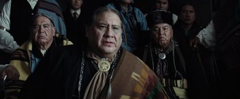 Movie still from “Killers of the Flower Moon” (2023), directed by Martin Scorsese – A group of men standing next to each other; Close Up shot, Over the shoulder angle