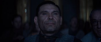 Movie still from “Killers of the Flower Moon” (2023), directed by Martin Scorsese – A person wearing a suit and tie; Close Up shot, Low angle