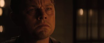 Movie still from “Killers of the Flower Moon” (2023), directed by Martin Scorsese – A man's face in the dark; Close Up shot, Low angle