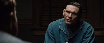 Movie still from “Killers of the Flower Moon” (2023), directed by Martin Scorsese – A person wearing a blue jacket; Close Up shot, Over the shoulder angle