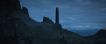 Movie still from “King Arthur: Legend of the Sword” (2017), directed by Guy Ritchie – A tall tower on top of a hill at night; Extreme Wide shot, Low angle