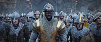 Movie still from “King Arthur: Legend of the Sword” (2017), directed by Guy Ritchie – A group of men in chainmaille armor and helmets; Medium shot, Low angle