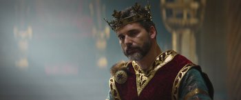 Movie still from “King Arthur: Legend of the Sword” (2017), directed by Guy Ritchie – A man with a beard wearing a crown; Close Up shot, Low angle