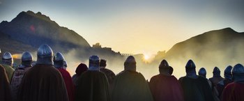 Movie still from “King Arthur: Legend of the Sword” (2017), directed by Guy Ritchie – A group of people standing on top of a hill; Extreme Wide shot, Low angle