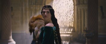 Movie still from “King Arthur: Legend of the Sword” (2017), directed by Guy Ritchie – A woman with long hair wearing a green dress; Close Up shot, Over the shoulder angle