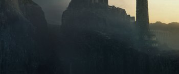 Movie still from “King Arthur: Legend of the Sword” (2017), directed by Guy Ritchie – A castle on top of a mountain with a dark sky; Extreme Wide shot, Low angle