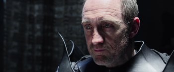 Movie still from “King Arthur: Legend of the Sword” (2017), directed by Guy Ritchie – A person wearing a helmet; Close Up shot, Low angle