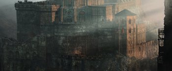 Movie still from “King Arthur: Legend of the Sword” (2017), directed by Guy Ritchie – An image of an old building in the middle of the night; Extreme Wide shot, High angle