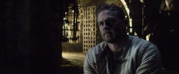 Movie still from “King Arthur: Legend of the Sword” (2017), directed by Guy Ritchie – A person wearing a jacket; Close Up shot, Over the shoulder angle