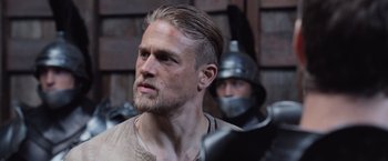 Movie still from “King Arthur: Legend of the Sword” (2017), directed by Guy Ritchie – A person with a helmet on; Close Up shot, Over the shoulder angle
