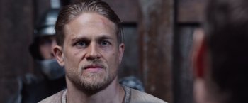 Movie still from “King Arthur: Legend of the Sword” (2017), directed by Guy Ritchie – A person with a beard; Close Up shot, Over the shoulder angle