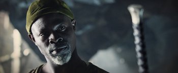 Movie still from “King Arthur: Legend of the Sword” (2017), directed by Guy Ritchie – A person with a hat on his head; Close Up shot, Low angle