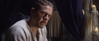 Movie still from “King Arthur: Legend of the Sword” (2017), directed by Guy Ritchie – A person with a beard; Close Up shot, Over the shoulder angle