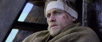 Movie still from “King Arthur: Legend of the Sword” (2017), directed by Guy Ritchie – A person with bandages on his head; Close Up shot, Low angle