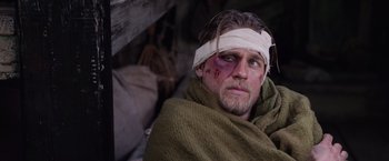 Movie still from “King Arthur: Legend of the Sword” (2017), directed by Guy Ritchie – A person with bandage on his head; Close Up shot, Over the shoulder angle