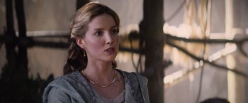 Movie still from “King Arthur: Legend of the Sword” (2017), directed by Guy Ritchie – A woman in a blue dress looking to her left; Close Up shot, Over the shoulder angle