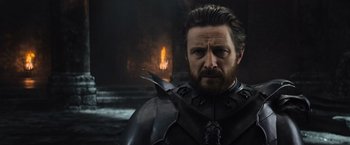 Movie still from “King Arthur: Legend of the Sword” (2017), directed by Guy Ritchie – A person wearing a suit of armor; Close Up shot, Over the shoulder angle