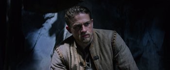 Movie still from “King Arthur: Legend of the Sword” (2017), directed by Guy Ritchie – A person with a beard; Close Up shot, Low angle