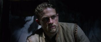 Movie still from “King Arthur: Legend of the Sword” (2017), directed by Guy Ritchie – A person with a beard; Close Up shot, Low angle