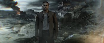 Movie still from “King Arthur: Legend of the Sword” (2017), directed by Guy Ritchie – A man standing in front of an old castle; Medium shot, Low angle