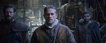 Movie still from “King Arthur: Legend of the Sword” (2017), directed by Guy Ritchie – A person wearing a jacket; Close Up shot, Low angle