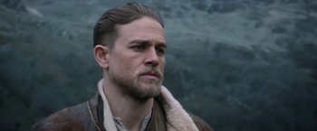 Movie still from “King Arthur: Legend of the Sword” (2017), directed by Guy Ritchie – A person with a beard; Close Up shot, Over the shoulder angle