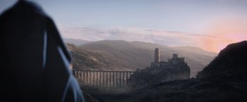 Movie still from “King Arthur: Legend of the Sword” (2017), directed by Guy Ritchie – A view of a bridge and a tower in the distance; Extreme Wide shot, Low angle