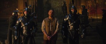 Movie still from “King Arthur: Legend of the Sword” (2017), directed by Guy Ritchie – A group of men standing next to each other in armor; Wide shot, Over the shoulder angle