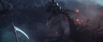 Movie still from “King Arthur: Legend of the Sword” (2017), directed by Guy Ritchie – An image of a man with a helmet on his head; Wide shot, Low angle