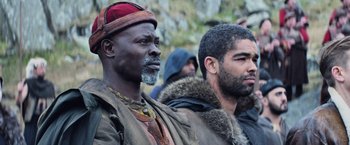 Movie still from “King Arthur: Legend of the Sword” (2017), directed by Guy Ritchie – A couple of men standing next to each other; Close Up shot, Low angle
