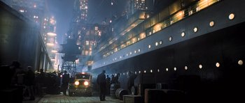 Movie still from “King Kong” (2005), directed by Peter Jackson – A group of men standing next to each other in front of a ship; Extreme Wide shot, Low angle
