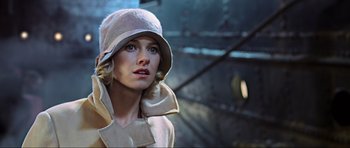 Movie still from “King Kong” (2005), directed by Peter Jackson – A woman wearing a hat and a trench coat; Close Up shot, Low angle