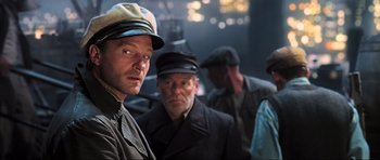 Movie still from “King Kong” (2005), directed by Peter Jackson – A group of men standing next to each other in a room; Medium shot, Low angle