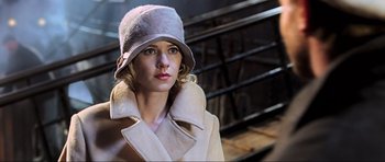 Movie still from “King Kong” (2005), directed by Peter Jackson – A woman wearing a hat and a white coat; Close Up shot, Low angle