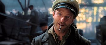 Movie still from “King Kong” (2005), directed by Peter Jackson – A person wearing a hat and smoking a cigarette; Close Up shot, Low angle