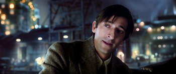 Movie still from “King Kong” (2005), directed by Peter Jackson – A person wearing a suit and tie; Close Up shot, Low angle