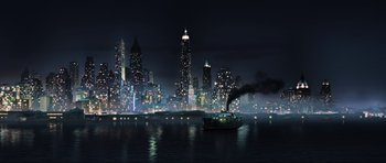 Movie still from “King Kong” (2005), directed by Peter Jackson – A boat floating on top of a body of water near tall buildings; Extreme Wide shot, High angle