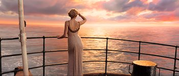 Movie still from “King Kong” (2005), directed by Peter Jackson – A woman standing on a deck looking out at the ocean; Wide shot, High angle