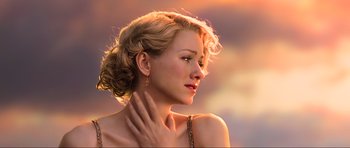 Movie still from “King Kong” (2005), directed by Peter Jackson – A beautiful woman with blonde curly hair wearing a necklace; Close Up shot, Over the shoulder angle