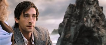Movie still from “King Kong” (2005), directed by Peter Jackson – A person wearing a suit and tie; Close Up shot, Over the shoulder angle