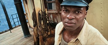 Movie still from “King Kong” (2005), directed by Peter Jackson – A man standing in front of ropes on a boat; Close Up shot, Low angle