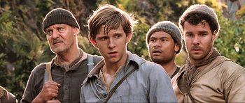 Movie still from “King Kong” (2005), directed by Peter Jackson – A group of men standing next to each other on top of a hill; Close Up shot, Low angle