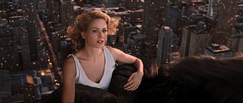 Movie still from “King Kong” (2005), directed by Peter Jackson – A woman sitting on top of a building in the city; Medium shot, Overhead angle