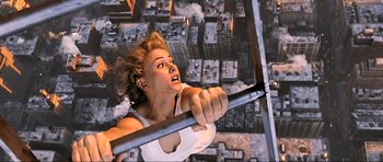Movie still from “King Kong” (2005), directed by Peter Jackson – A woman holding onto a metal pole in front of an aerial view of a city; Close Up shot, Overhead angle