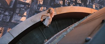 Movie still from “King Kong” (2005), directed by Peter Jackson – A woman is jumping in the air on a trampoline; Wide shot, Overhead angle