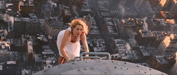 Movie still from “King Kong” (2005), directed by Peter Jackson – A woman in a white dress is on top of a building; Medium shot, Overhead angle